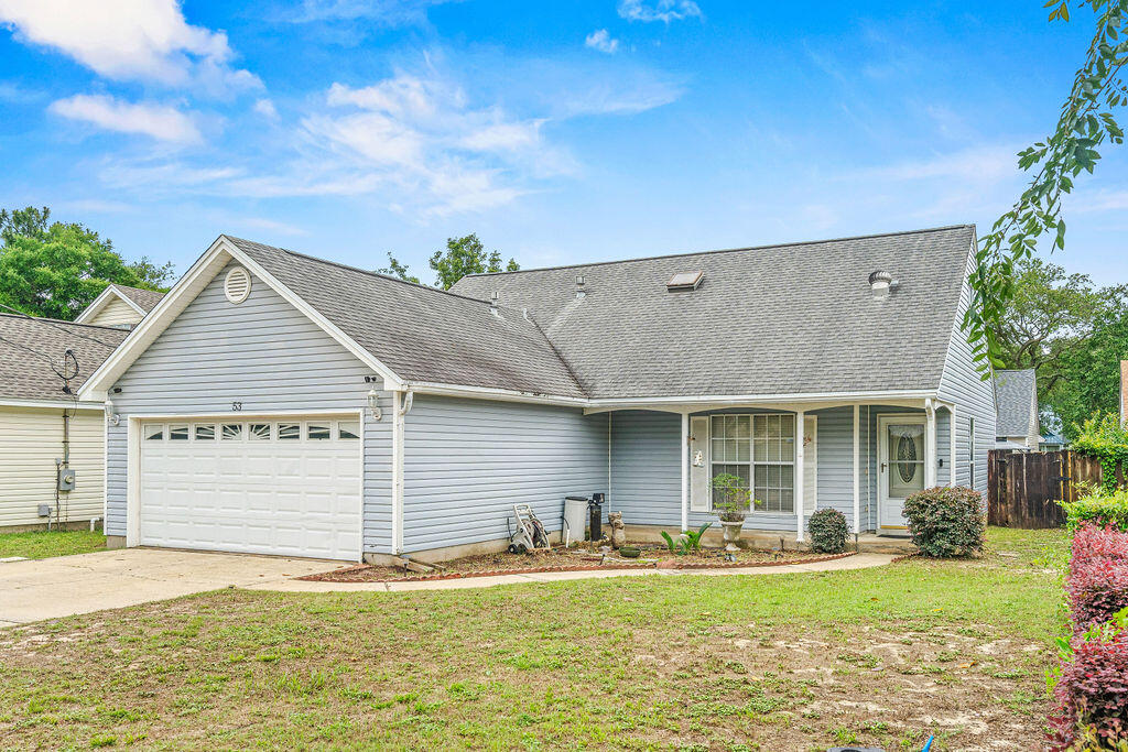53 4th Street Shalimar, FL 32579 - Photo 2 of 47 a front view of a house with a yard