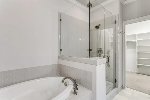 a bathroom with a tub a sink and a shower