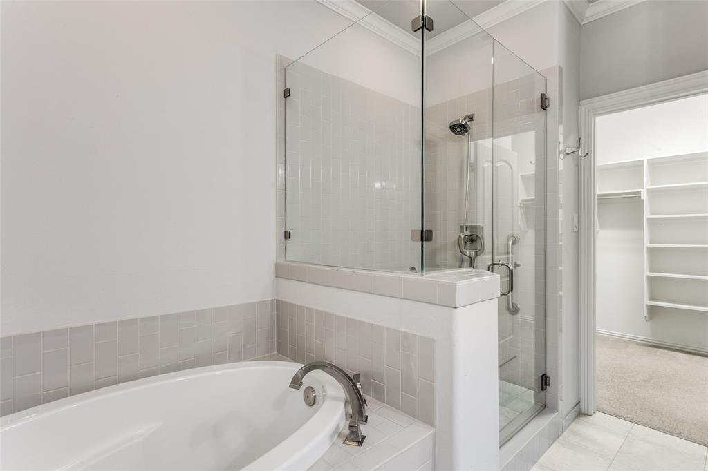 2221 Churchill Loop Grapevine, TX 76051 - Photo 14 of 26 a bathroom with a tub a sink and a shower