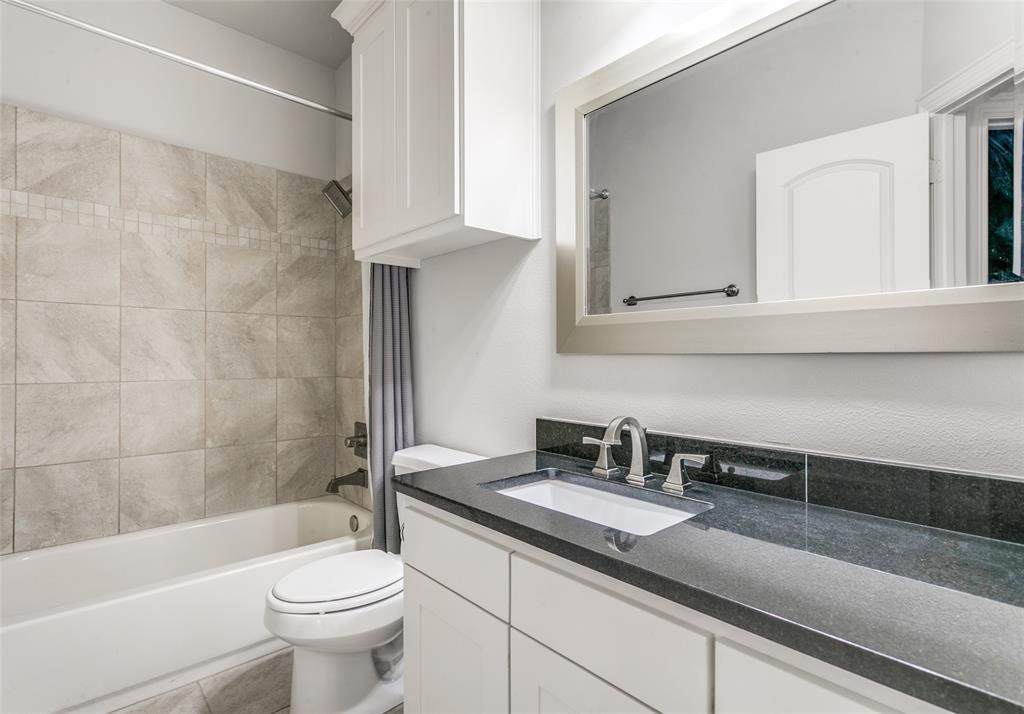 2221 Churchill Loop Grapevine, TX 76051 - Photo 18 of 26 a bathroom with a sink a toilet and bathtub