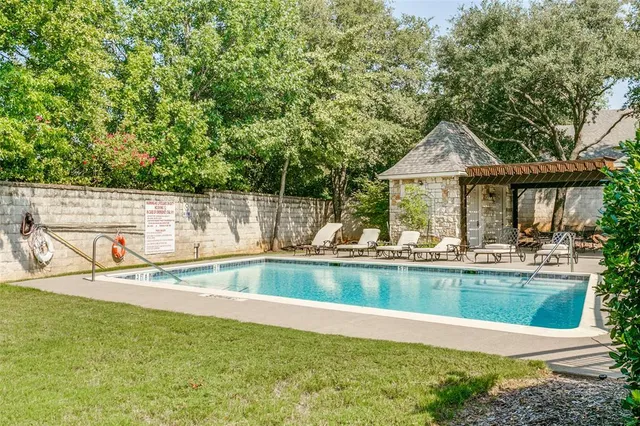 a backyard of a house with a yard and outdoor seating