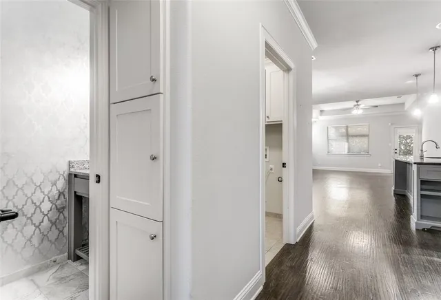 a view of a hallway with wooden floor