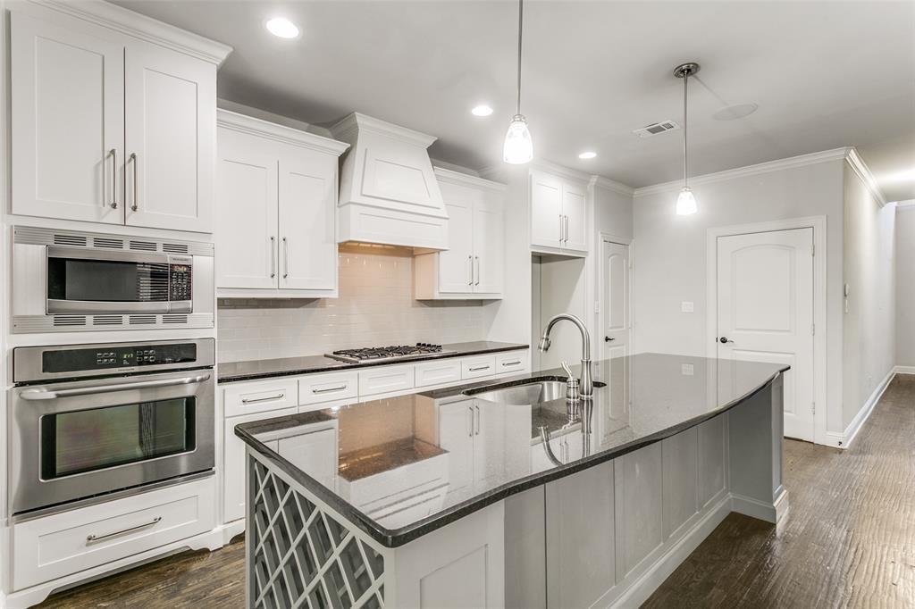 2221 Churchill Loop Grapevine, TX 76051 - Photo 4 of 26 a kitchen that has a sink a stove and a microwave