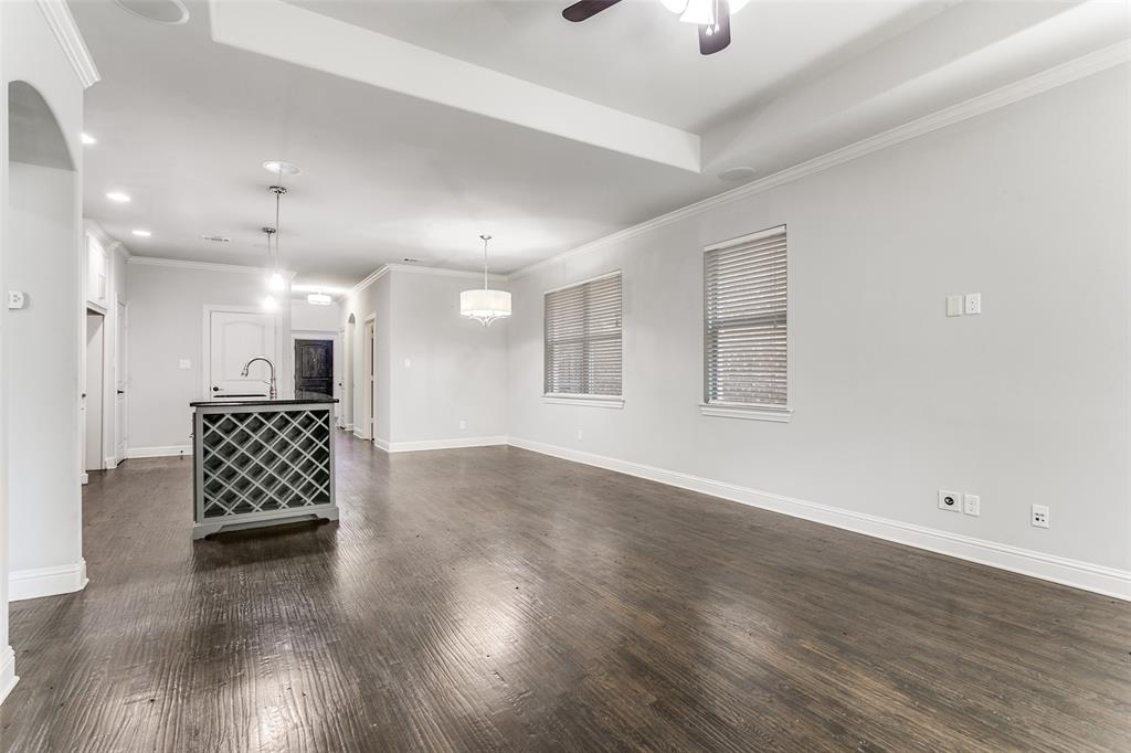 2221 Churchill Loop Grapevine, TX 76051 - Photo 5 of 26 an empty room with wooden floor cabinet and windows