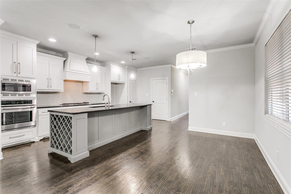 2221 Churchill Loop Grapevine, TX 76051 - Photo 10 of 26 a large kitchen with stainless steel appliances a large counter top a sink a refrigerator and a window