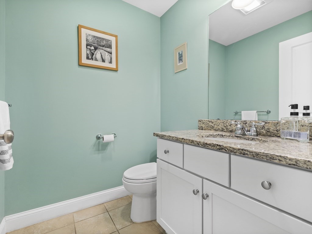 38 Webster Street, Unit 1 Needham, MA 02494 - Photo 11 of 35 a bathroom with a granite countertop toilet sink and mirror