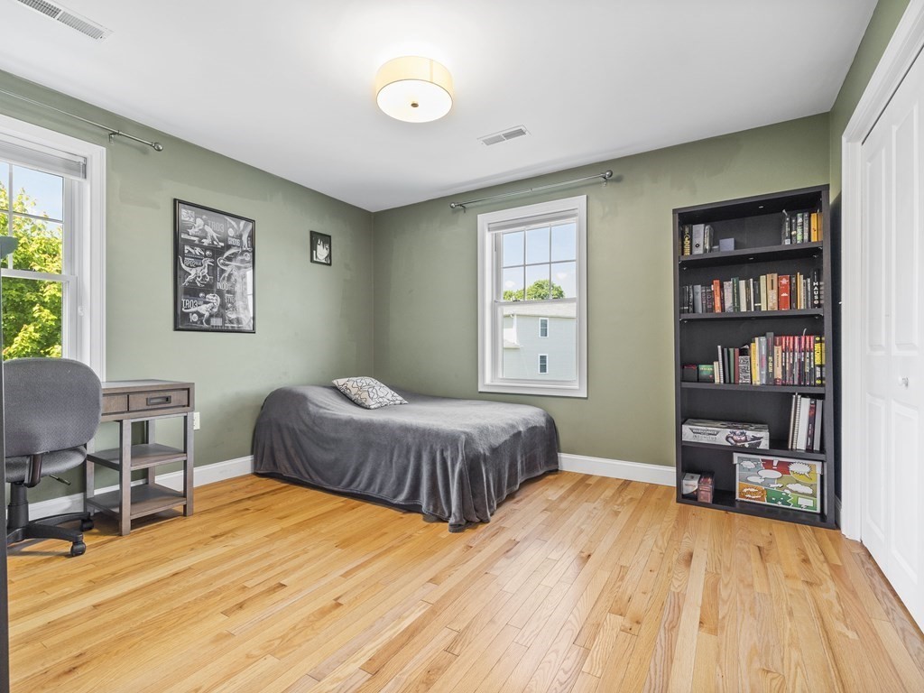 38 Webster Street, Unit 1 Needham, MA 02494 - Photo 15 of 35 a bedroom with a bed and a workspace