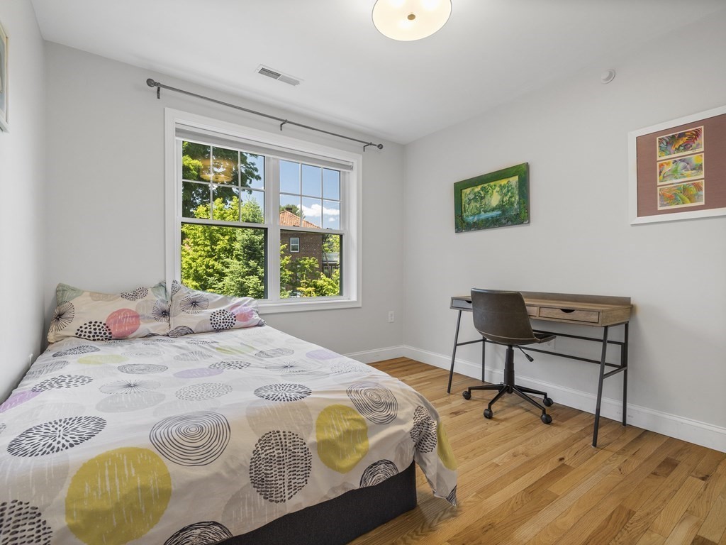 38 Webster Street, Unit 1 Needham, MA 02494 - Photo 17 of 35 a bedroom with a bed and a window