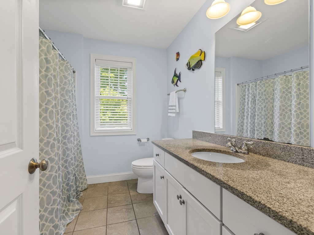 38 Webster Street, Unit 1 Needham, MA 02494 - Photo 18 of 35 a bathroom with a granite countertop sink and a mirror