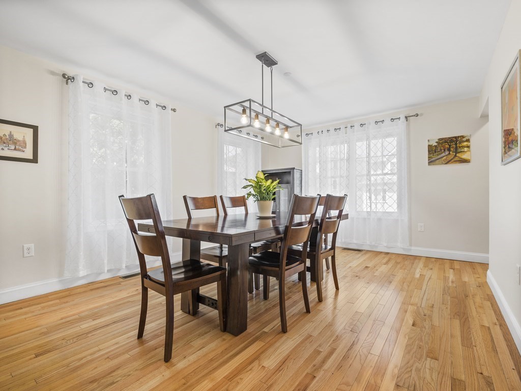 38 Webster Street, Unit 1 Needham, MA 02494 - Photo 9 of 35 a view of a dining room with furniture and wooden floor