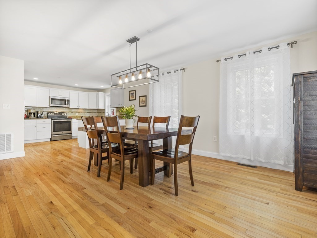 38 Webster Street, Unit 1 Needham, MA 02494 - Photo 10 of 35 a view of a dining room with furniture and wooden floor