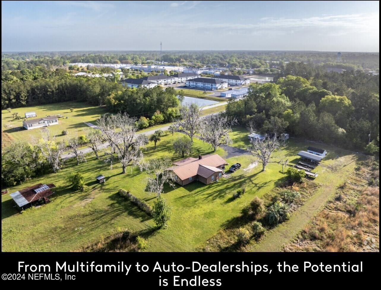 an aerial view of swimming pool with a yard