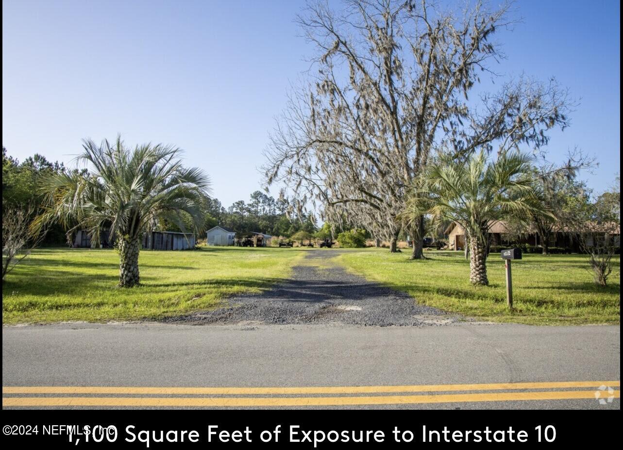 5464 George Hodges Road Macclenny, FL 32063 - Photo 12 of 23 a view of swimming pool with a yard and palm trees