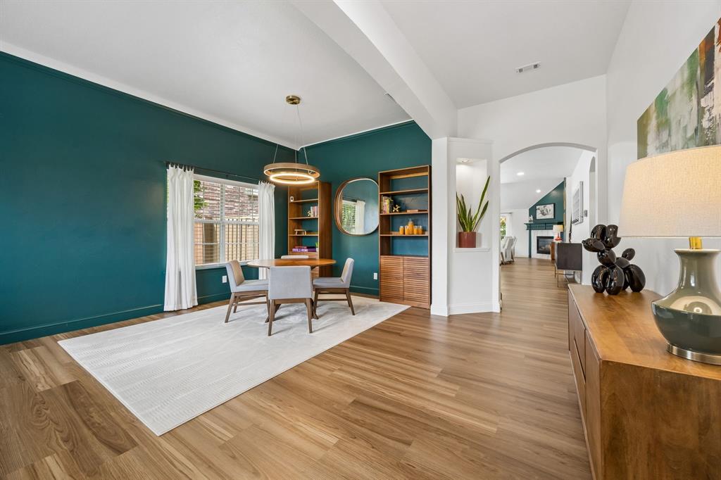 9217 Inverness Drive Rowlett, TX 75089 - Photo 3 of 40 Bright Entry with Versatile Gathering Space — Tall ceilings, LVP flooring, and abundant natural light give this front living and dining area an open, airy feel with room for both everyday use and special occasions.