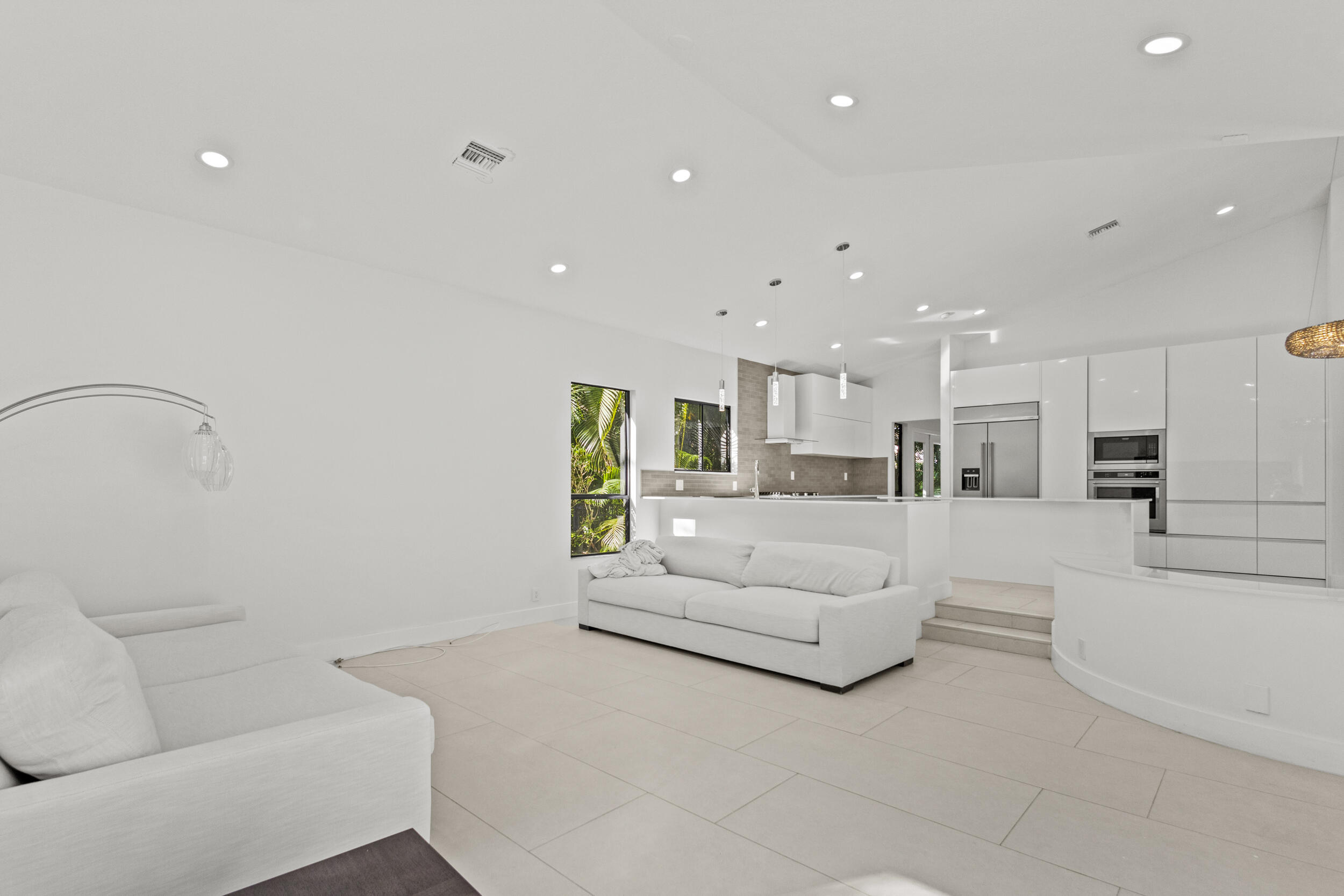 4798 Northwest 25th Way Boca Raton, FL 33434 - Photo 13 of 41 a living room with furniture and a view of kitchen