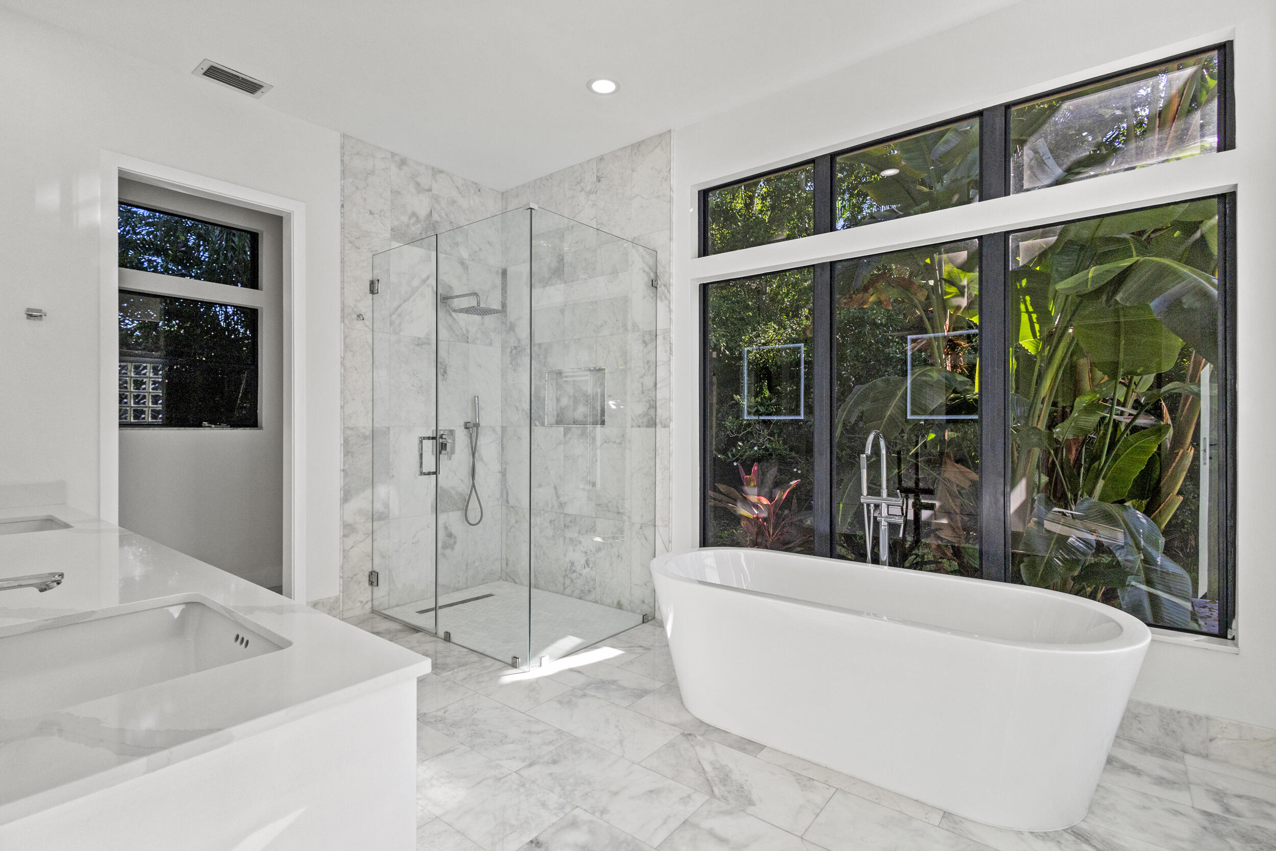 4798 Northwest 25th Way Boca Raton, FL 33434 - Photo 20 of 41 a bathroom with a large tub a shower and view