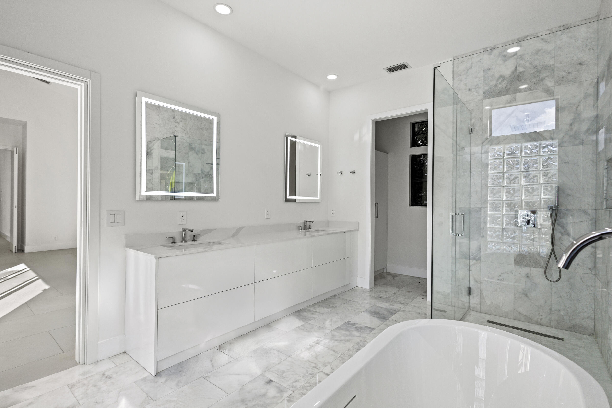 4798 Northwest 25th Way Boca Raton, FL 33434 - Photo 21 of 41 a spacious bathroom with a tub shower and mirror