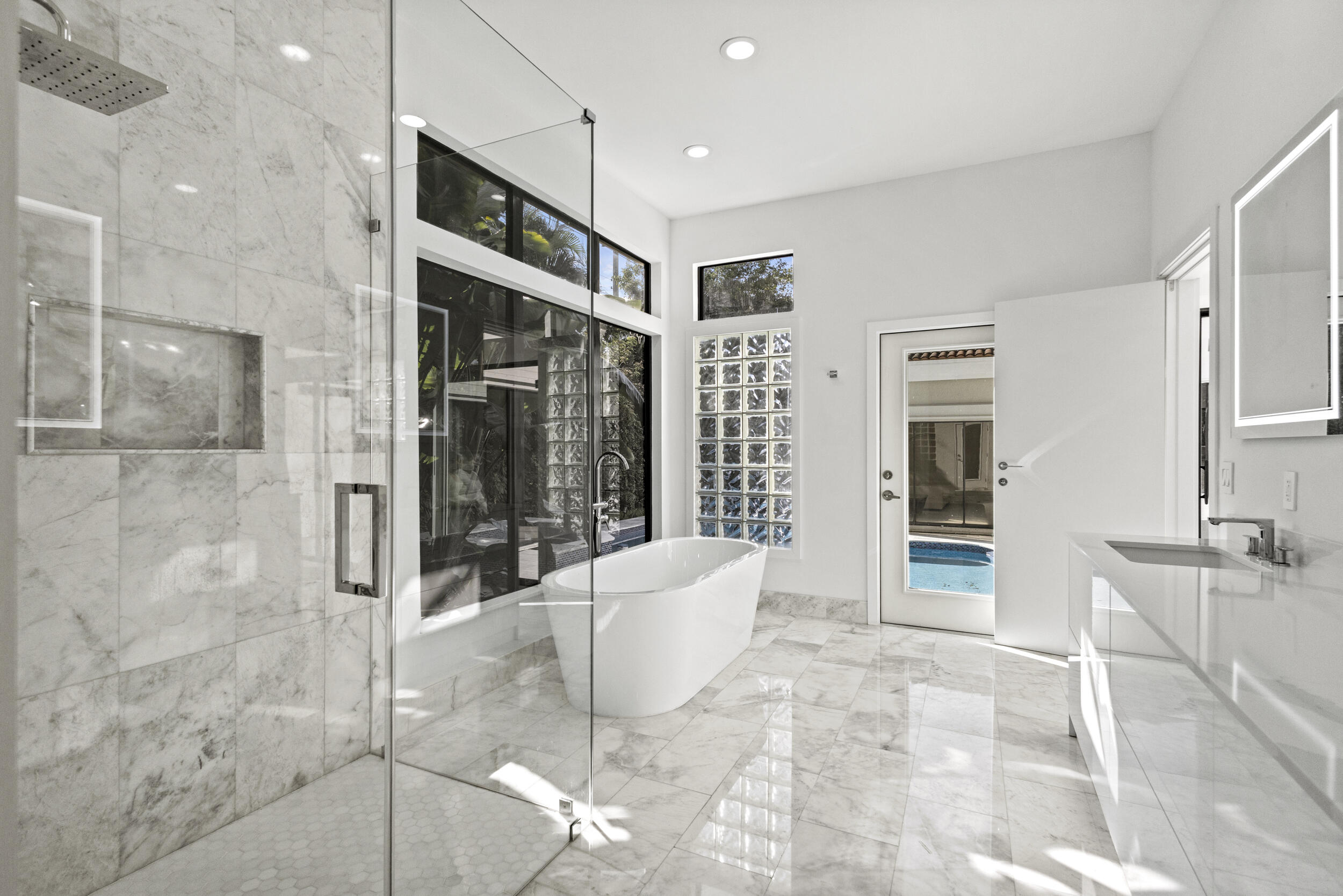 4798 Northwest 25th Way Boca Raton, FL 33434 - Photo 22 of 41 a spacious bathroom with a granite countertop shower a sink and a mirror