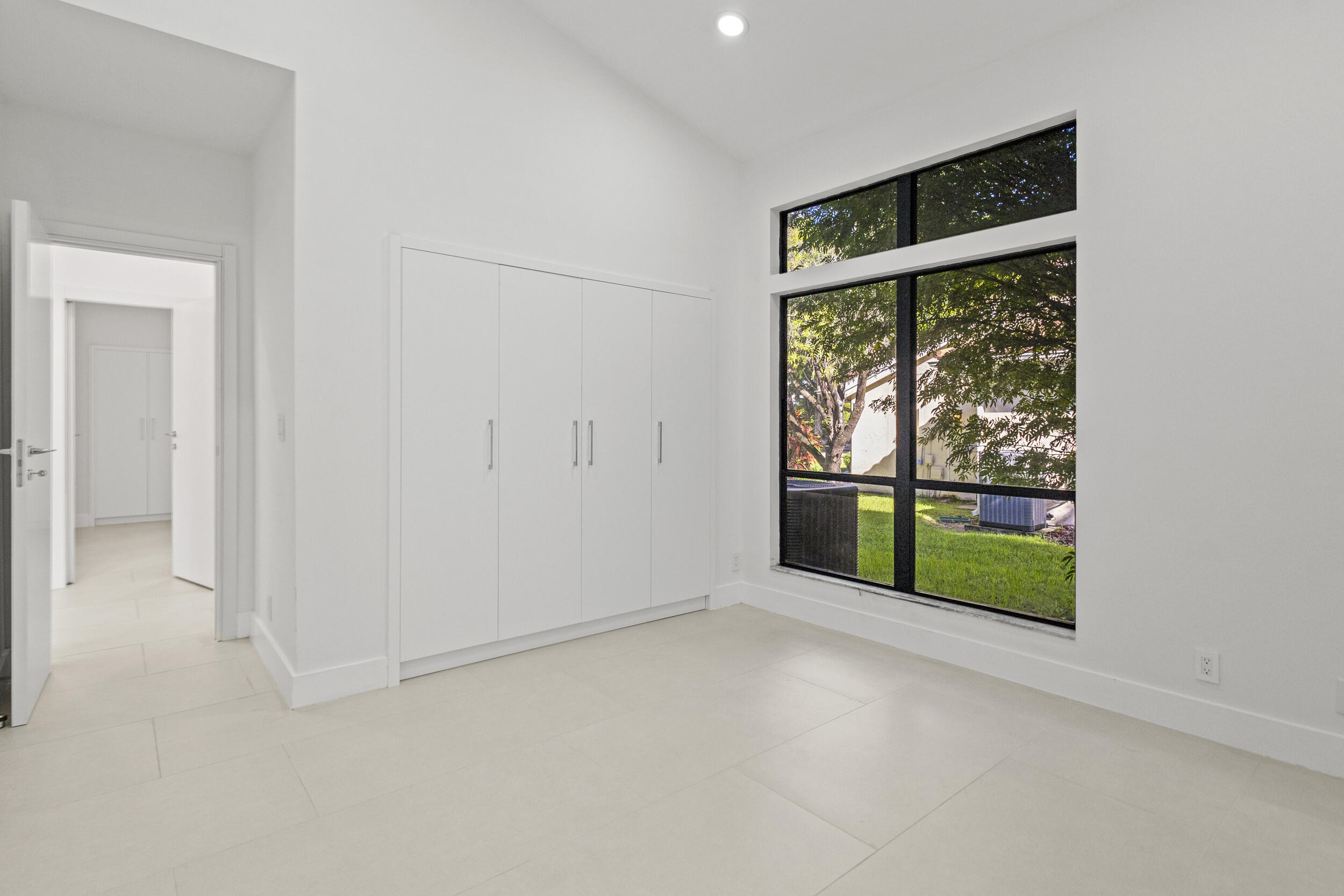 4798 Northwest 25th Way Boca Raton, FL 33434 - Photo 25 of 41 an empty room with sliding door