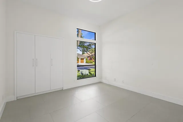 an empty room with windows and entrance