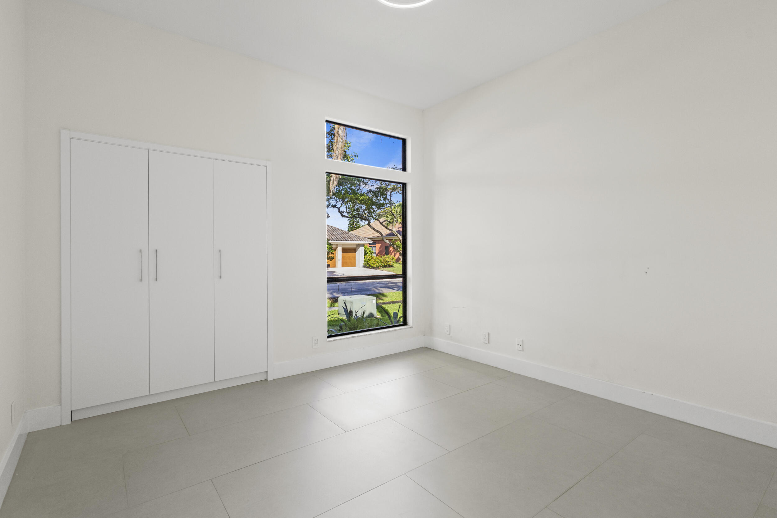 4798 Northwest 25th Way Boca Raton, FL 33434 - Photo 26 of 41 an empty room with windows and entrance