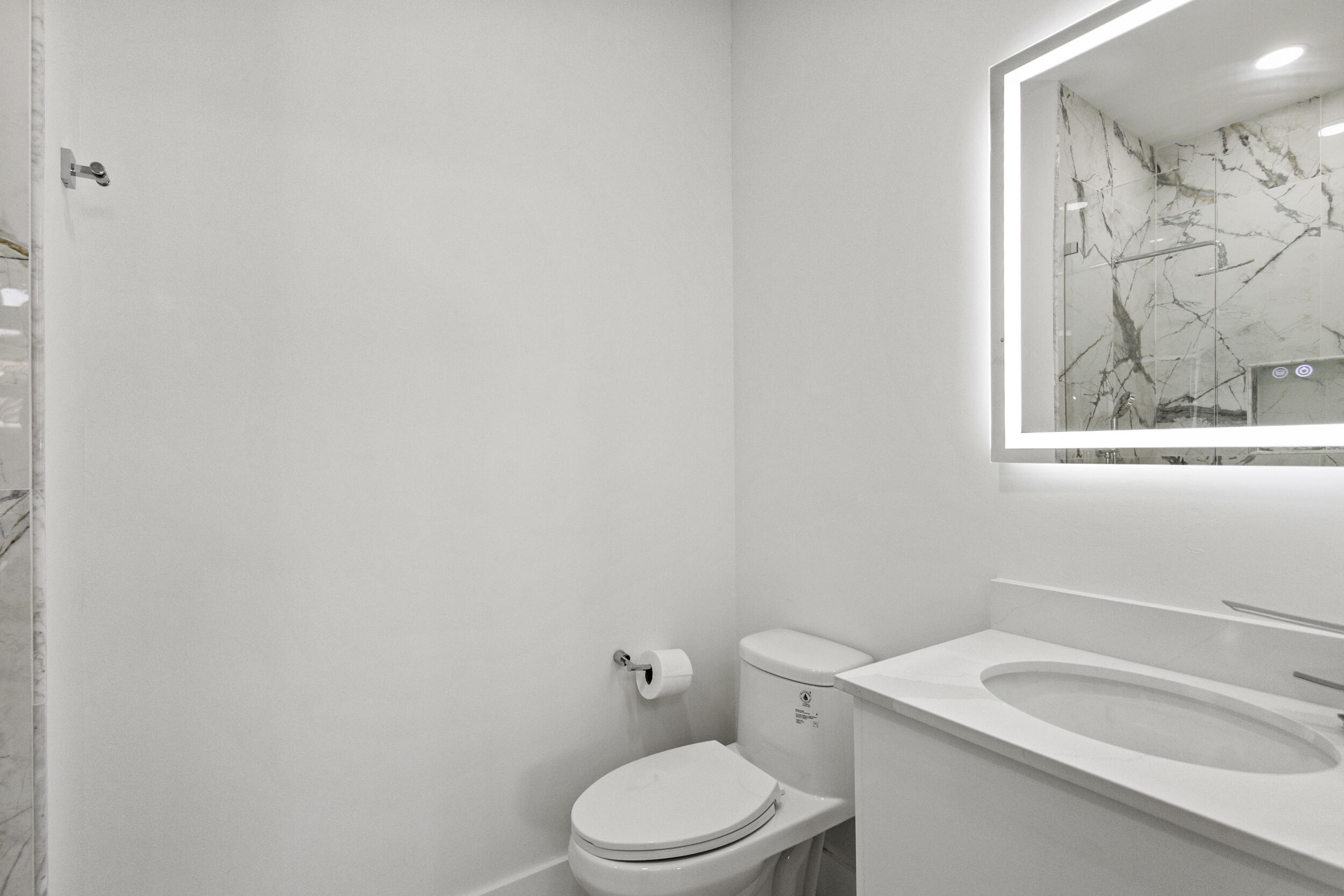 4798 Northwest 25th Way Boca Raton, FL 33434 - Photo 29 of 41 a white toilet sitting next to a bathroom sink