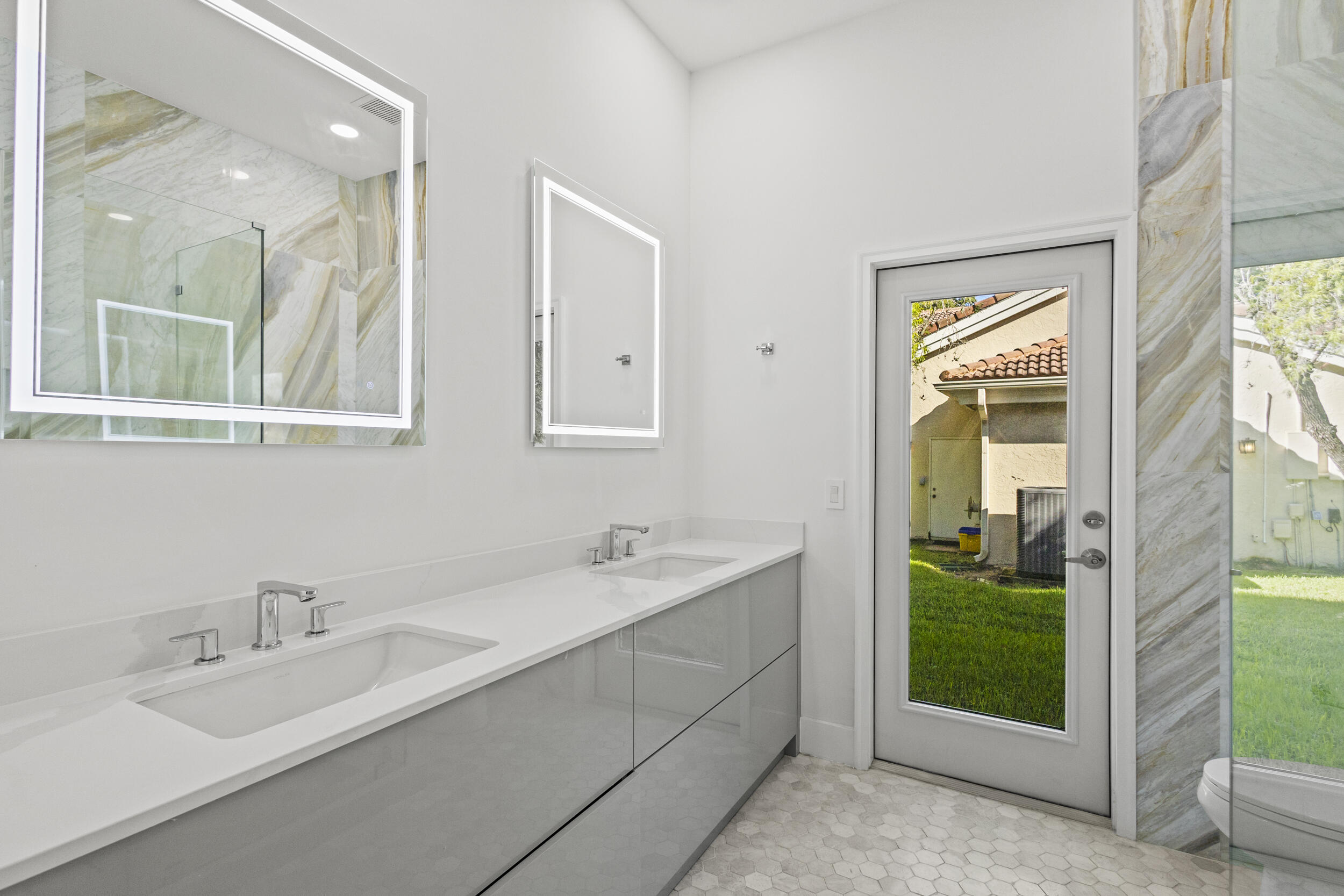 4798 Northwest 25th Way Boca Raton, FL 33434 - Photo 30 of 41 a en suite bathroom with a double vanity sink and mirror