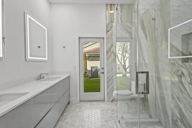 a white toilet sitting next to a bathroom sink