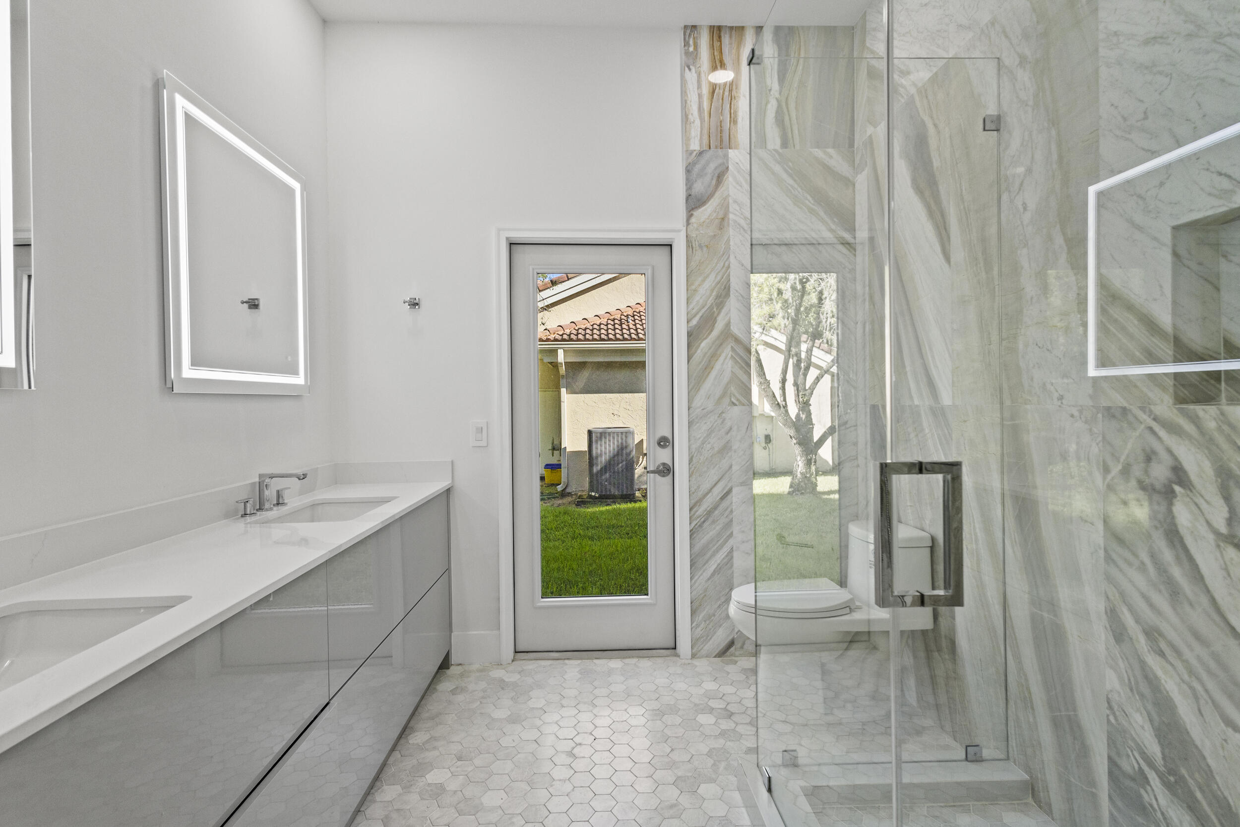 4798 Northwest 25th Way Boca Raton, FL 33434 - Photo 31 of 41 a bathroom with a tub sink and mirror
