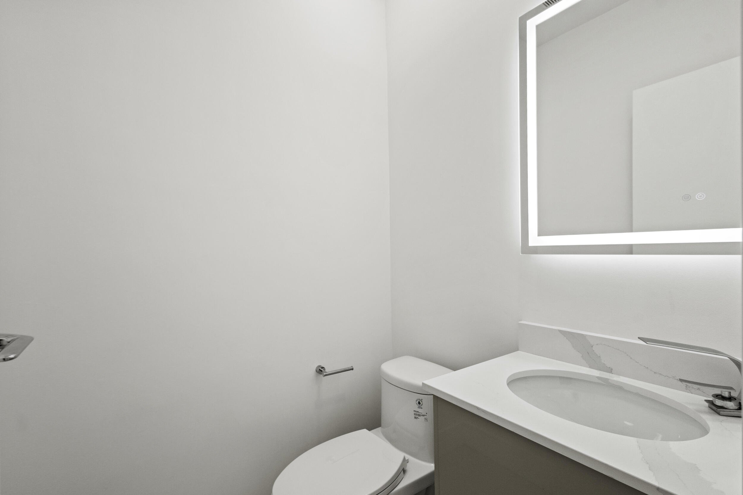 4798 Northwest 25th Way Boca Raton, FL 33434 - Photo 32 of 41 a white toilet sitting next to a bathroom sink