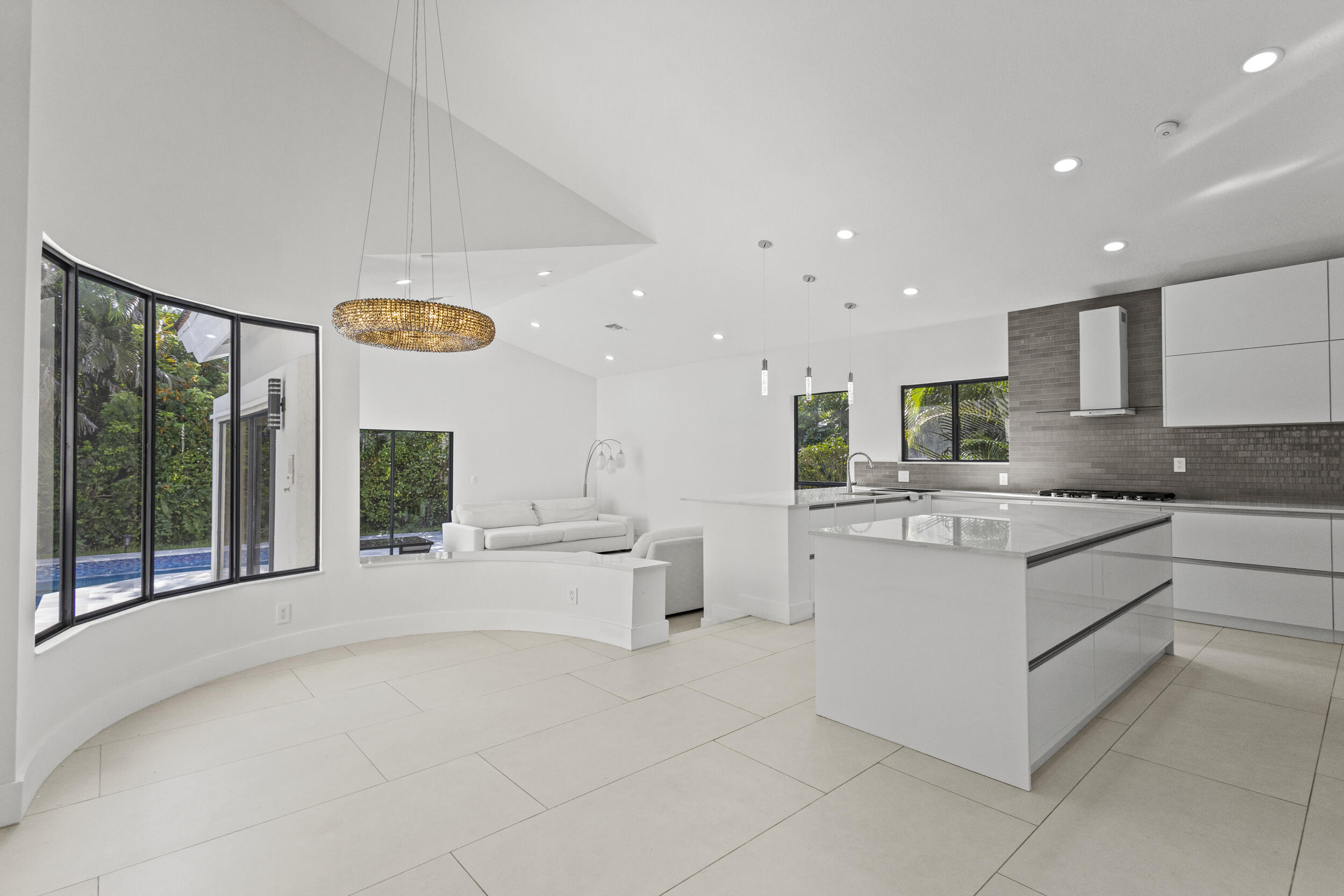 4798 Northwest 25th Way Boca Raton, FL 33434 - Photo 8 of 41 a large white kitchen with a large window and stainless steel appliances