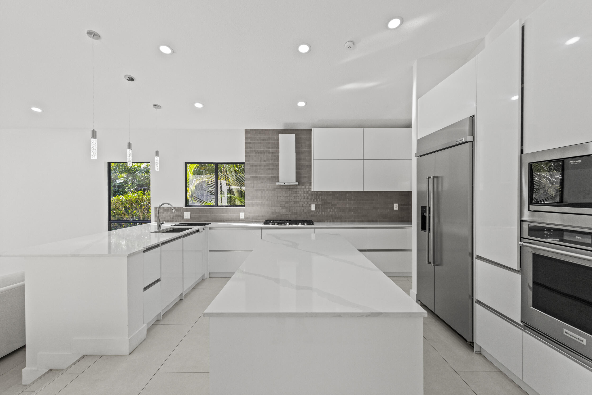 4798 Northwest 25th Way Boca Raton, FL 33434 - Photo 10 of 41 a large kitchen with stainless steel appliances kitchen island granite countertop a refrigerator and a sink