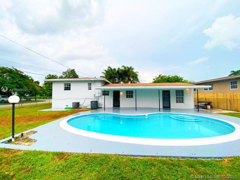 1275 Northeast 204th Terrace Miami, FL 33179 - Photo 13 of 49 a swimming pool with outdoor seating yard and barbeque oven