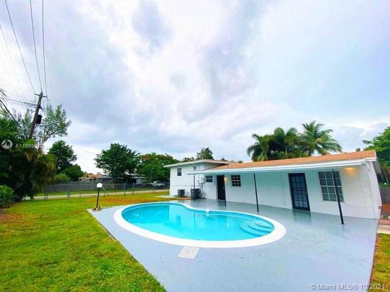 1275 Northeast 204th Terrace Miami, FL 33179 - Photo 14 of 49 a front view of a house with a yard
