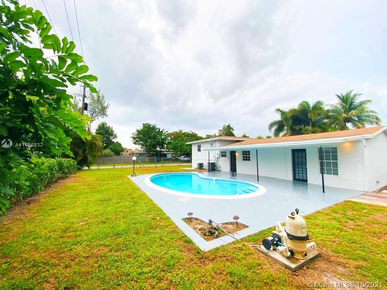 1275 Northeast 204th Terrace Miami, FL 33179 - Photo 15 of 49 a swimming pool with outdoor seating yard and barbeque oven