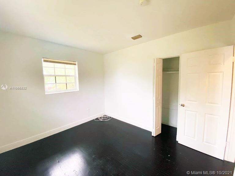 1275 Northeast 204th Terrace Miami, FL 33179 - Photo 17 of 49 an empty room with wooden floor and windows