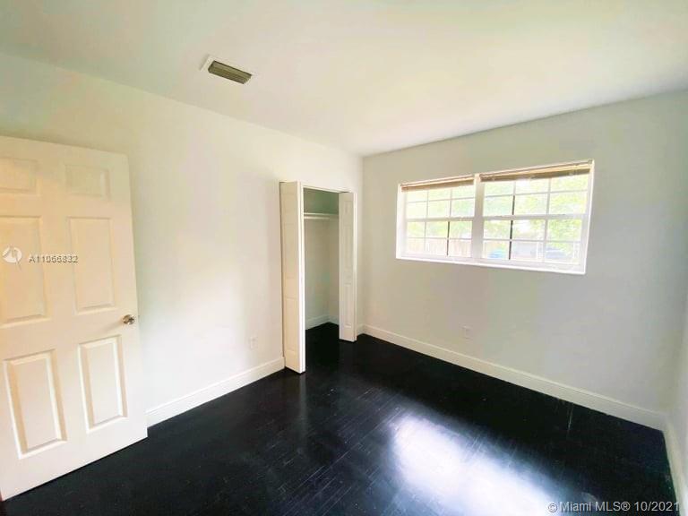 1275 Northeast 204th Terrace Miami, FL 33179 - Photo 18 of 49 a view of an empty room with wooden floor and a window