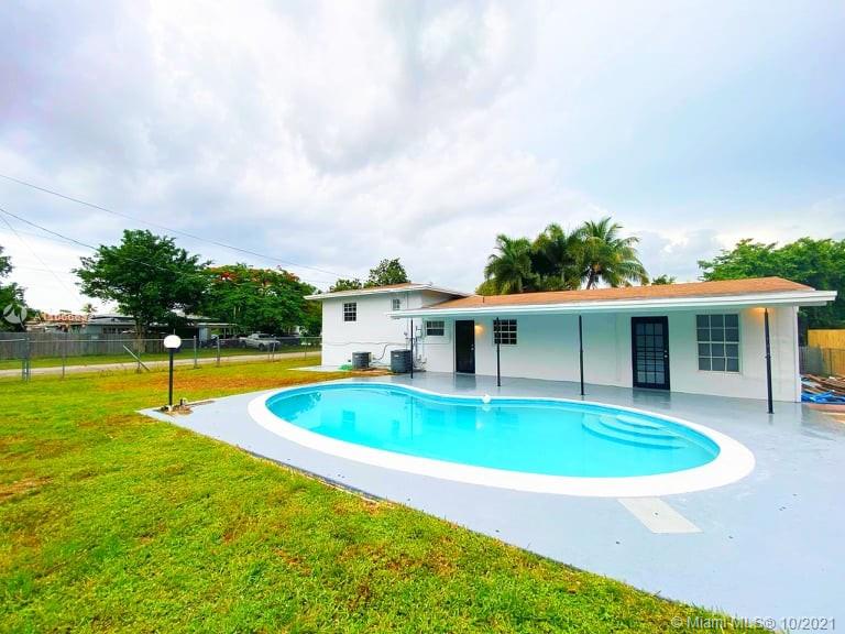 1275 Northeast 204th Terrace Miami, FL 33179 - Photo 2 of 49 a swimming pool with outdoor seating yard and barbeque oven