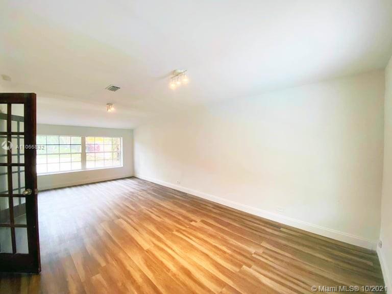 1275 Northeast 204th Terrace Miami, FL 33179 - Photo 25 of 49 a view of an empty room and wooden floor