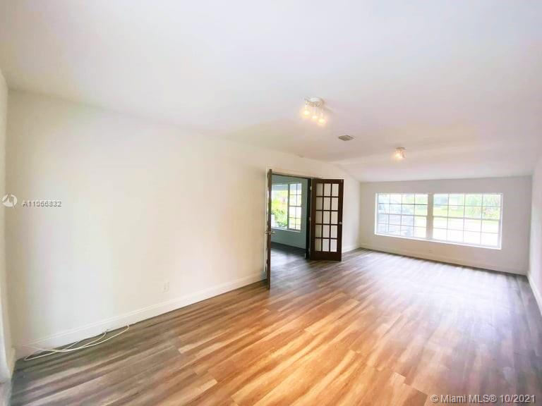 1275 Northeast 204th Terrace Miami, FL 33179 - Photo 26 of 49 an empty room with wooden floor and windows