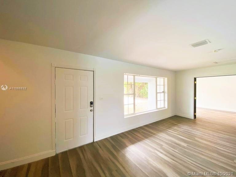 1275 Northeast 204th Terrace Miami, FL 33179 - Photo 27 of 49 a view of an empty room with wooden floor and a window