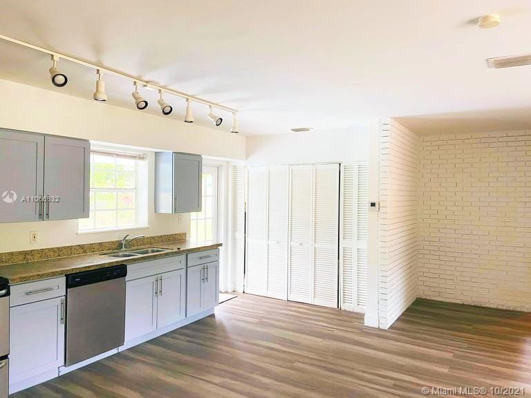 1275 Northeast 204th Terrace Miami, FL 33179 - Photo 28 of 49 a view of a kitchen with granite countertop cabinets stainless steel appliances and a counter space