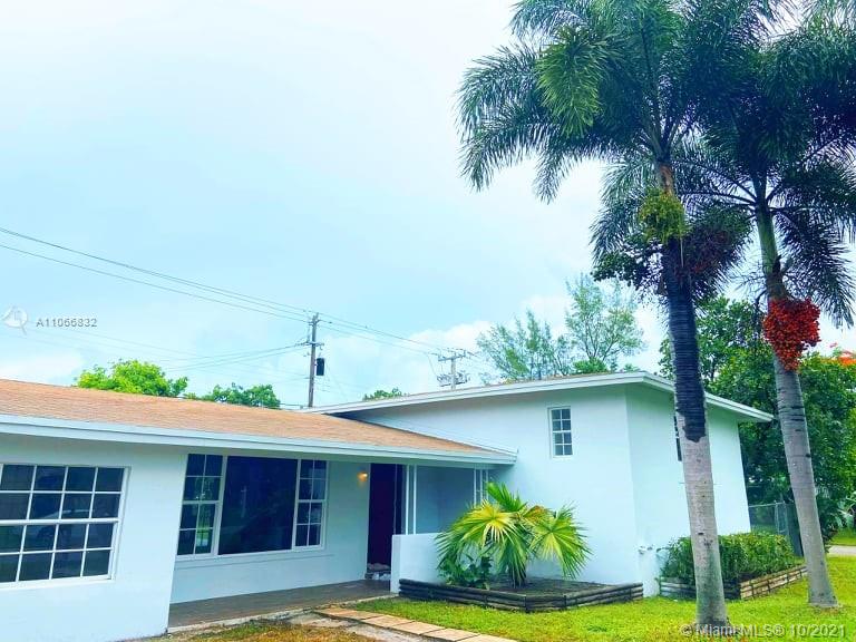 1275 Northeast 204th Terrace Miami, FL 33179 - Photo 3 of 49 a front view of a house with garden