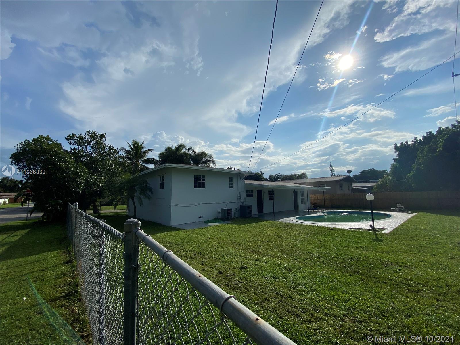 1275 Northeast 204th Terrace Miami, FL 33179 - Photo 43 of 49 a view of a terrace with a garden