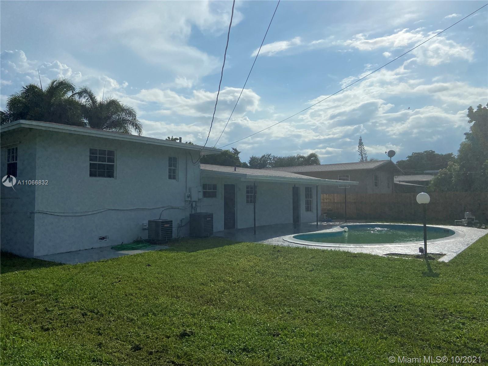 1275 Northeast 204th Terrace Miami, FL 33179 - Photo 45 of 49 a backyard of apartments with large tree