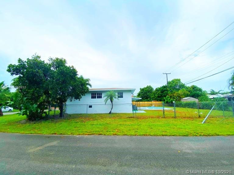 1275 Northeast 204th Terrace Miami, FL 33179 - Photo 7 of 49 a view of a house with a big yard and a large trees
