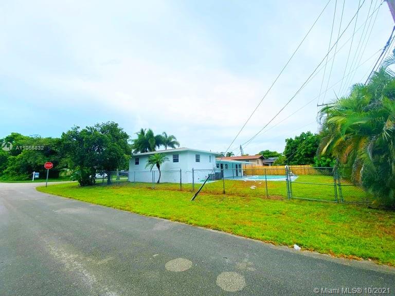 1275 Northeast 204th Terrace Miami, FL 33179 - Photo 8 of 49 a view of an house with pool and a yard