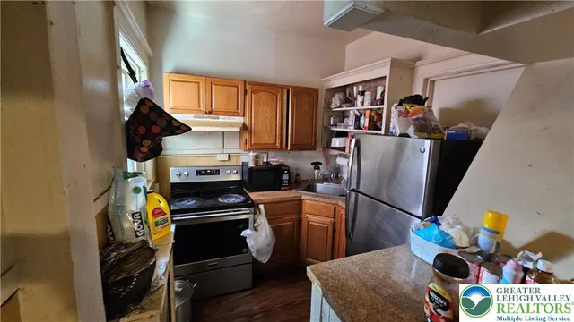 a view of a workspace with furniture and wooden floor
