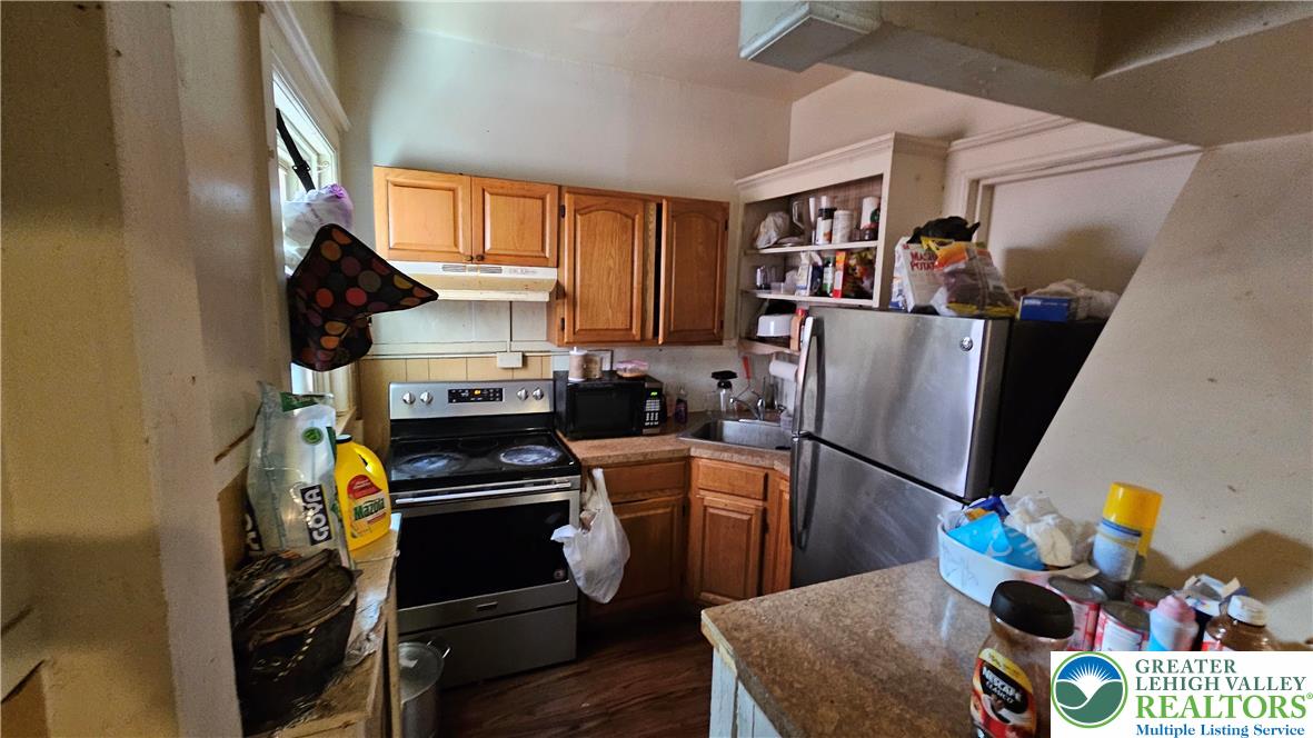 504 Tilghman Street Allentown, PA 18102 - Photo 23 of 33 a kitchen with stainless steel appliances granite countertop a refrigerator and a stove