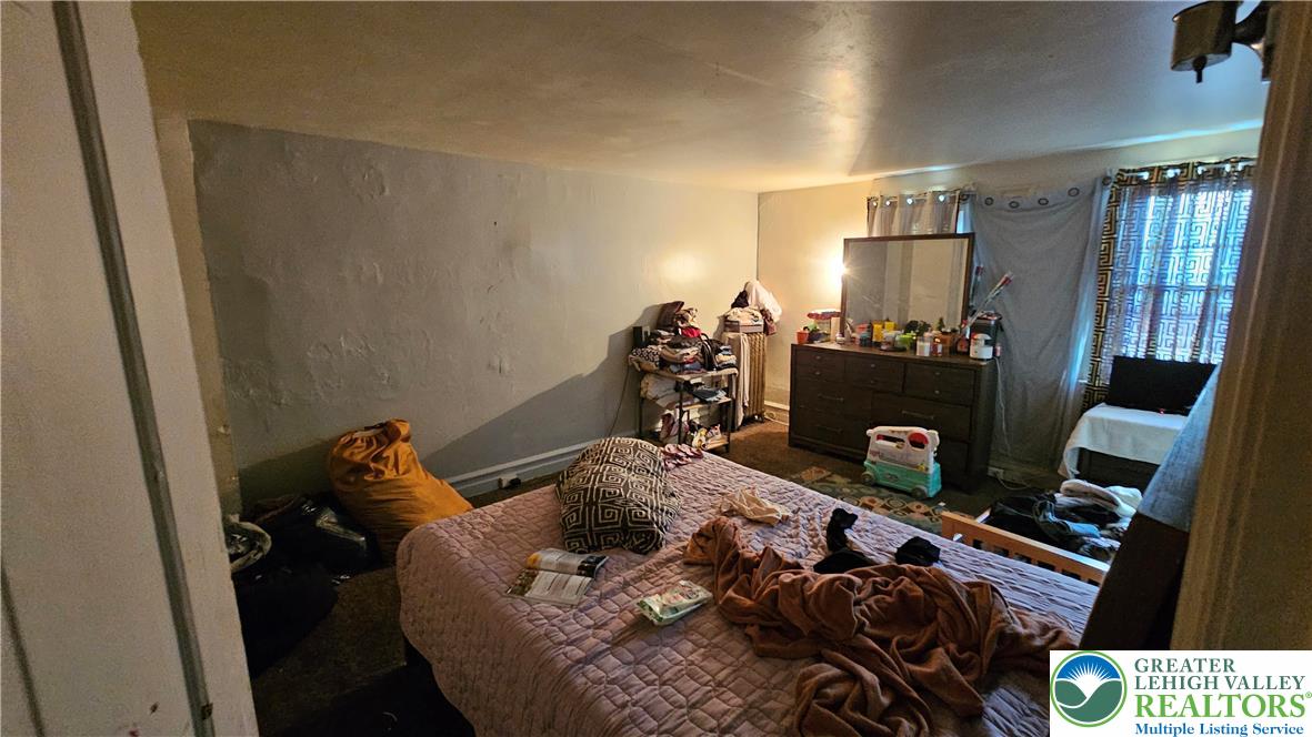 504 Tilghman Street Allentown, PA 18102 - Photo 28 of 33 a bedroom with a bed and wooden floor